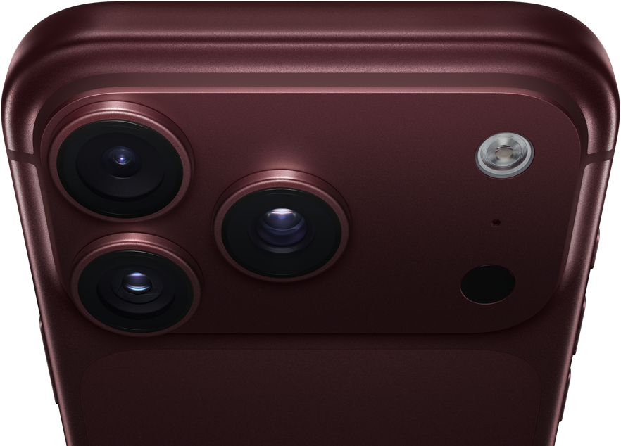 Un iPhone 18 Pro Max, couleur bourgogne (rouge foncé), face arrière, système caméra Pro Fusion dans la partie supérieure, 3 objectifs, lames d’ouverture variable partiellement fermées, flash, microphone et scanneur LiDAR, dessus, antenne cellulaire, côtés plats, bords arrondis
