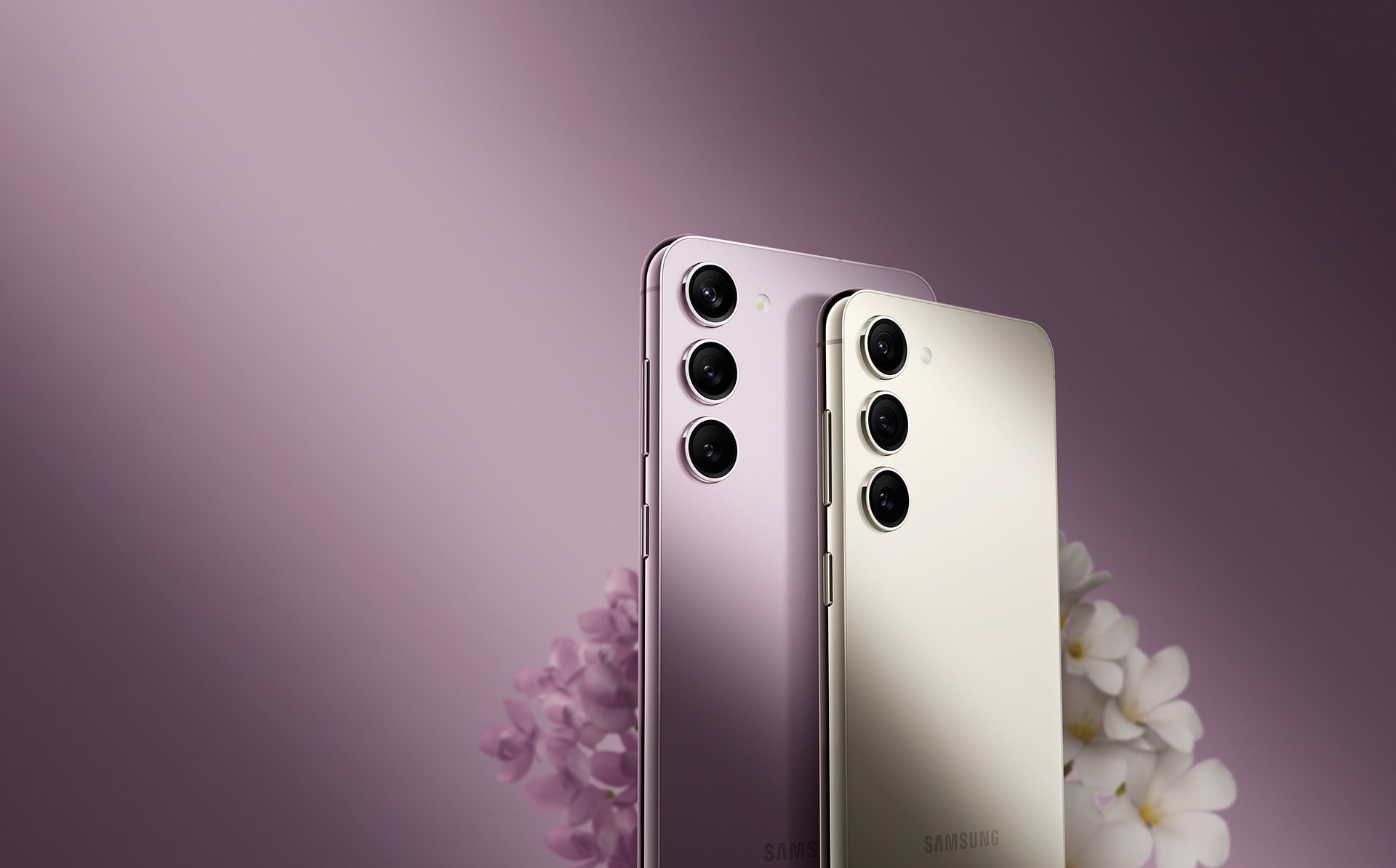 Galaxy S23 in Cream and S23 plus in Lavender are side by side and seen from the rear at a slight angle that shows the metal frame on the side.