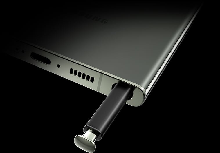 A close up of the bottom portion of Galaxy S23 Ultra, seen at an angle from the rear. The S Pen is slightly ejected from the bottom of the phone.