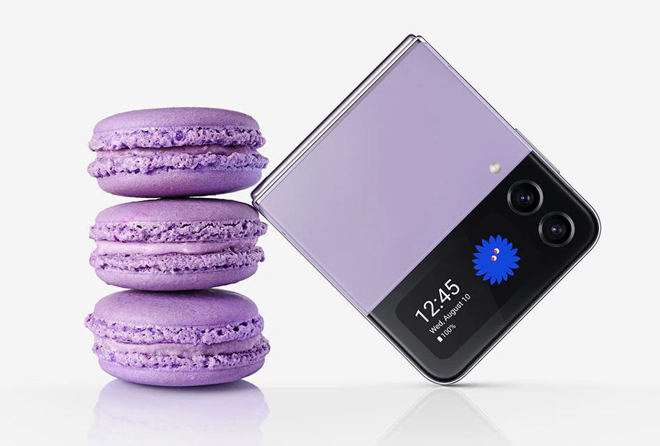 A folded Galaxy Z
				Flip4 in Bora Purple seen from the Cover Screen. It leans against a stack of three macarons of the same colour. The
				folded device is similar in size to three stacked macarons.