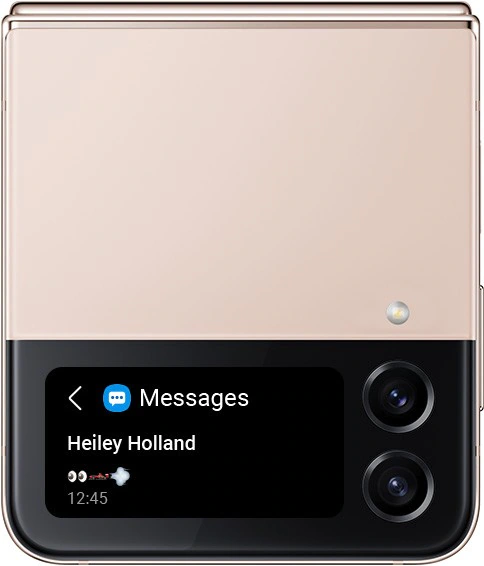 A folded Pink Gold Galaxy Z Flip4 with a text message notification on the Cover Screen. It shows a series of
			emoji symbols: eyes, race car and wind.