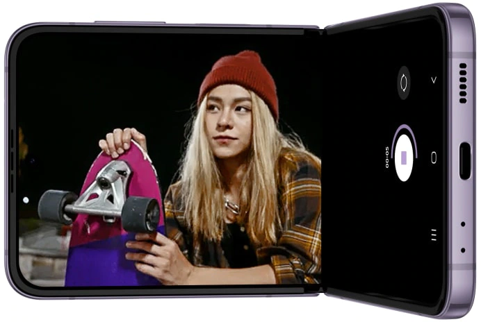 Galaxy Z Flip4 is
				seen in Flex mode. On the Main Screen, the camera app is seen recording a video of skateboarders at night. The
				subjects are clear and the video is smooth, even in low light.