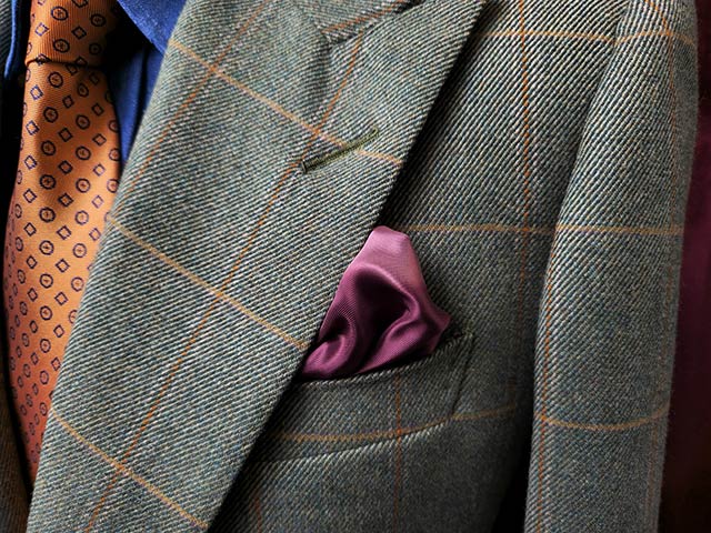 A close up shot
				of a suit jacket with a handkerchief in the front pocket. The fabric's lines are distinct and colours are rich
				thanks to Detail Enhancer.