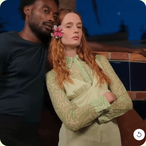 Close-up of a couple leaning against each other zooms out to include a blurred palm tree in the background