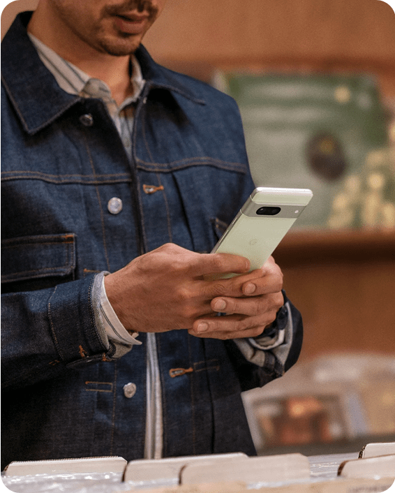 A close-up of two hands holding a Pixel 7