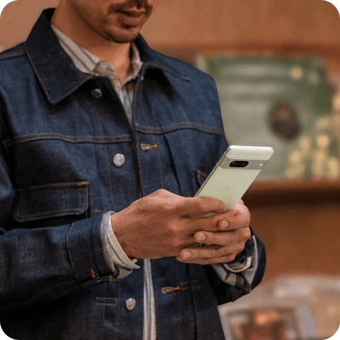 A close-up of two hands holding a Pixel 7